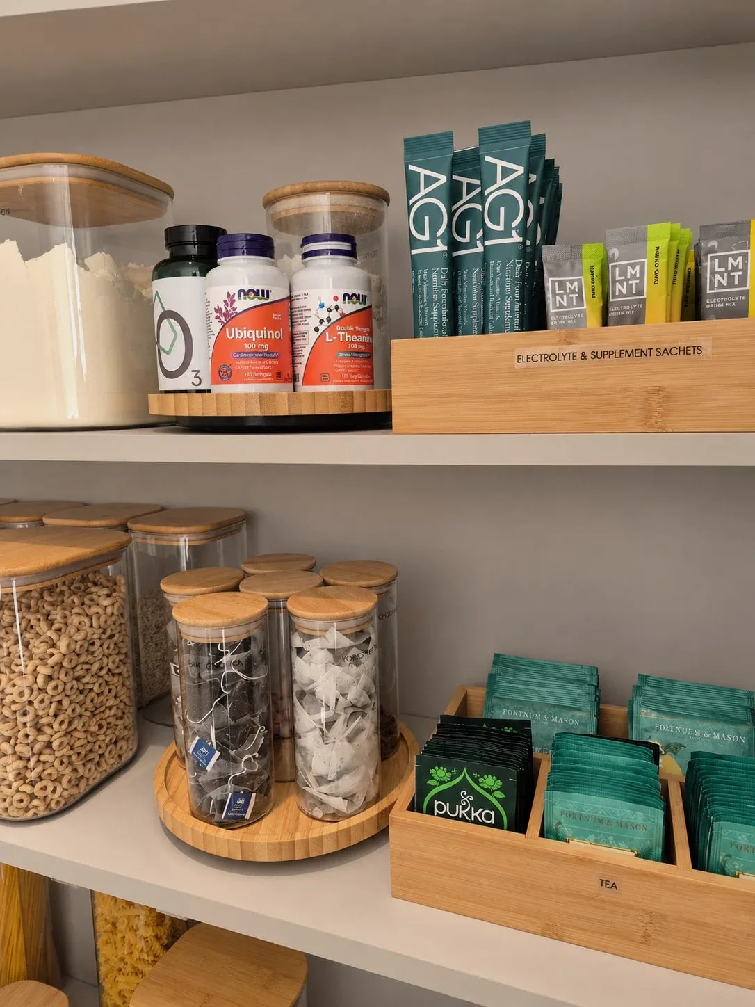 Jars and packets on a turntable in a pantry cupboard.