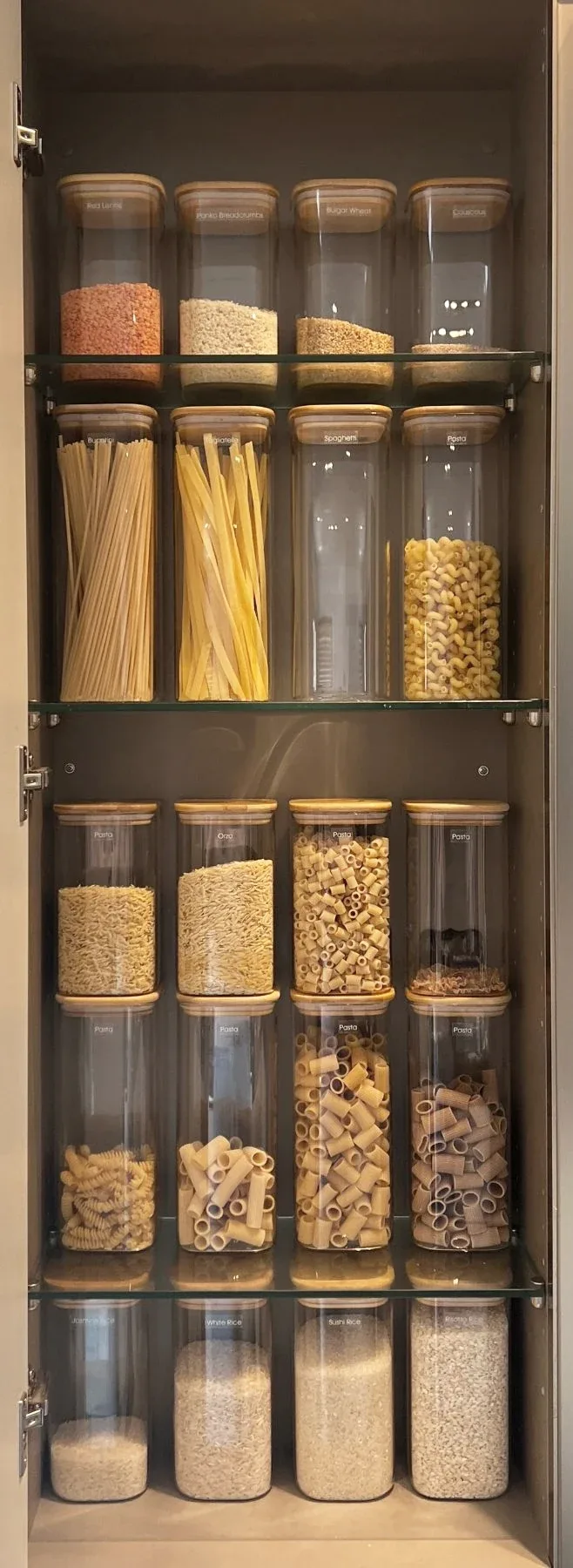 A slim pull-out pantry of decanted pasta and pulses.
