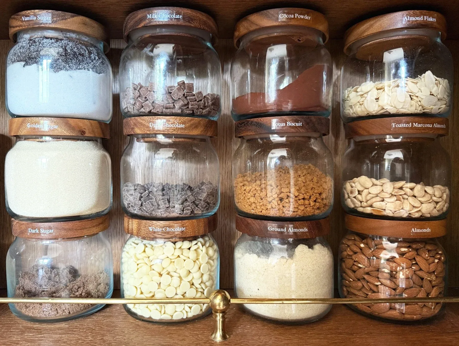 Large glass jars of flour, grains and nuts, stacked two deep.