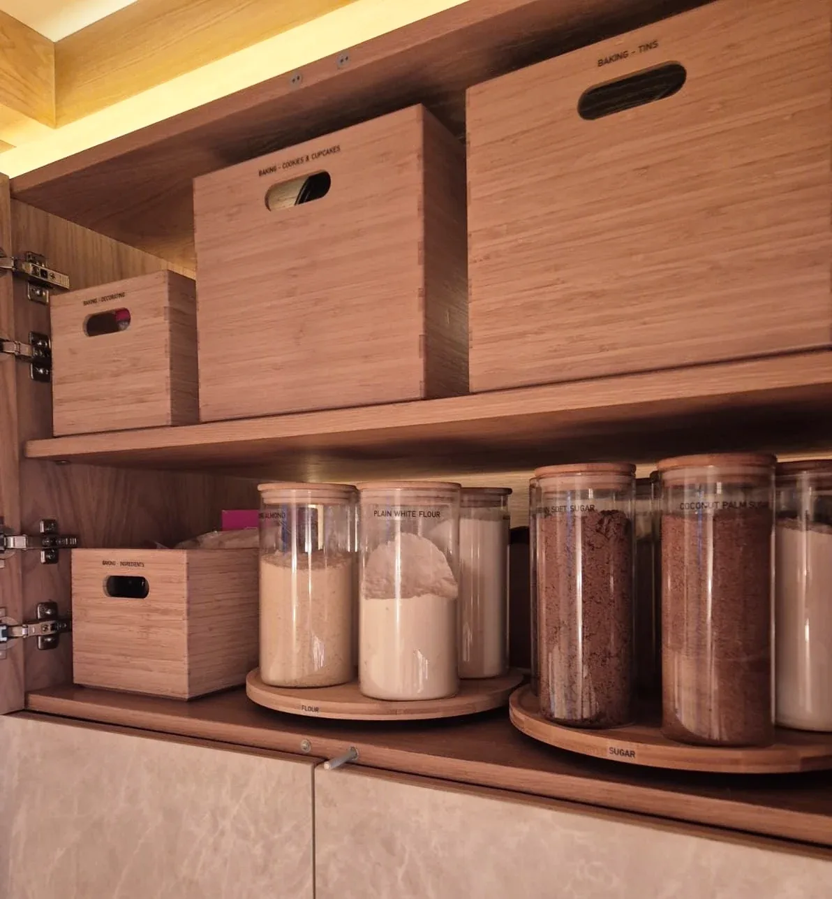 Timber crates above jars of flour and sugar on a turntable.