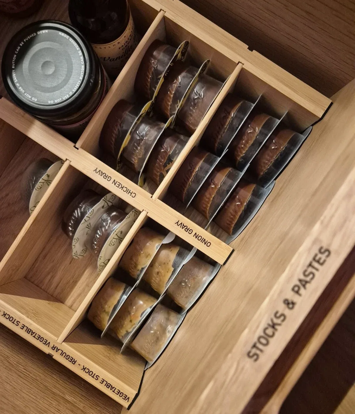 A drawer divided into compartments for stocks and pastes.