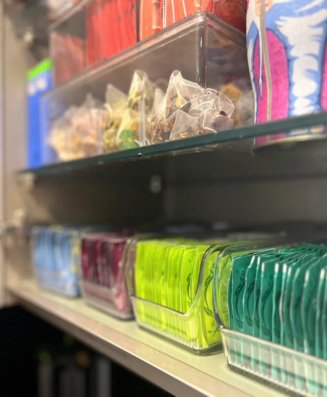 A pull-out drawer of packets and snacks sorted upright.