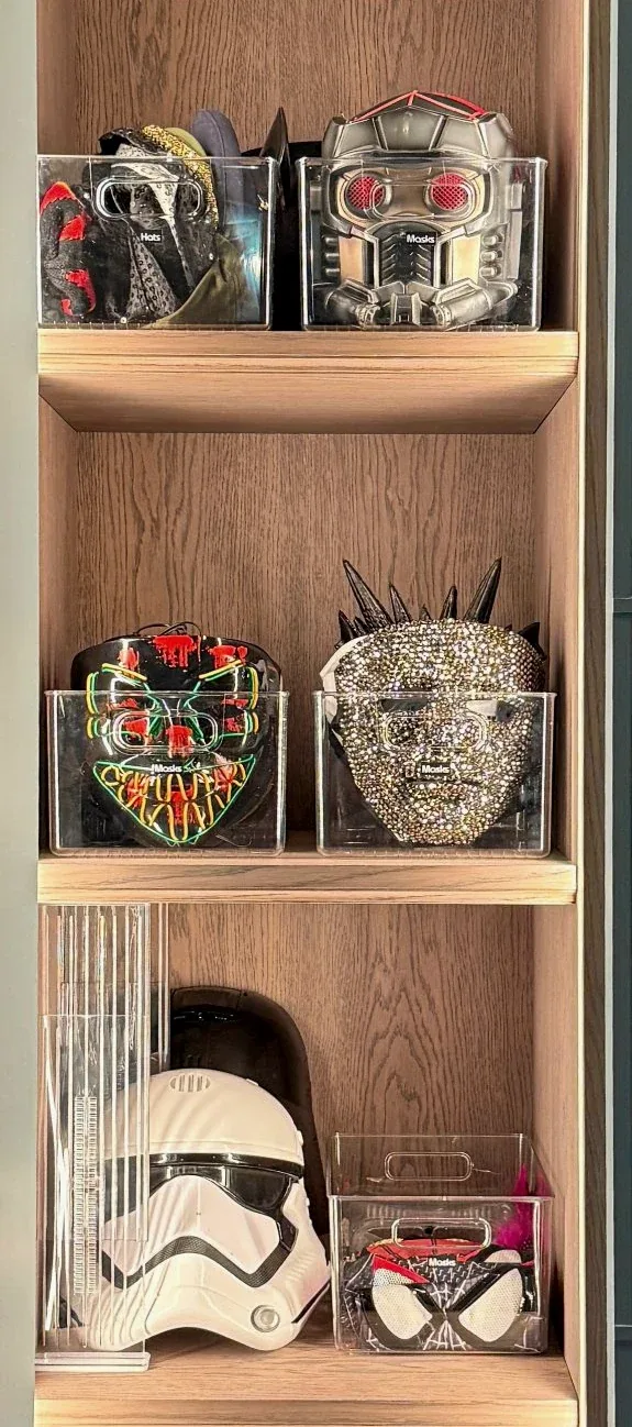 Model helmets displayed on lit shelves.