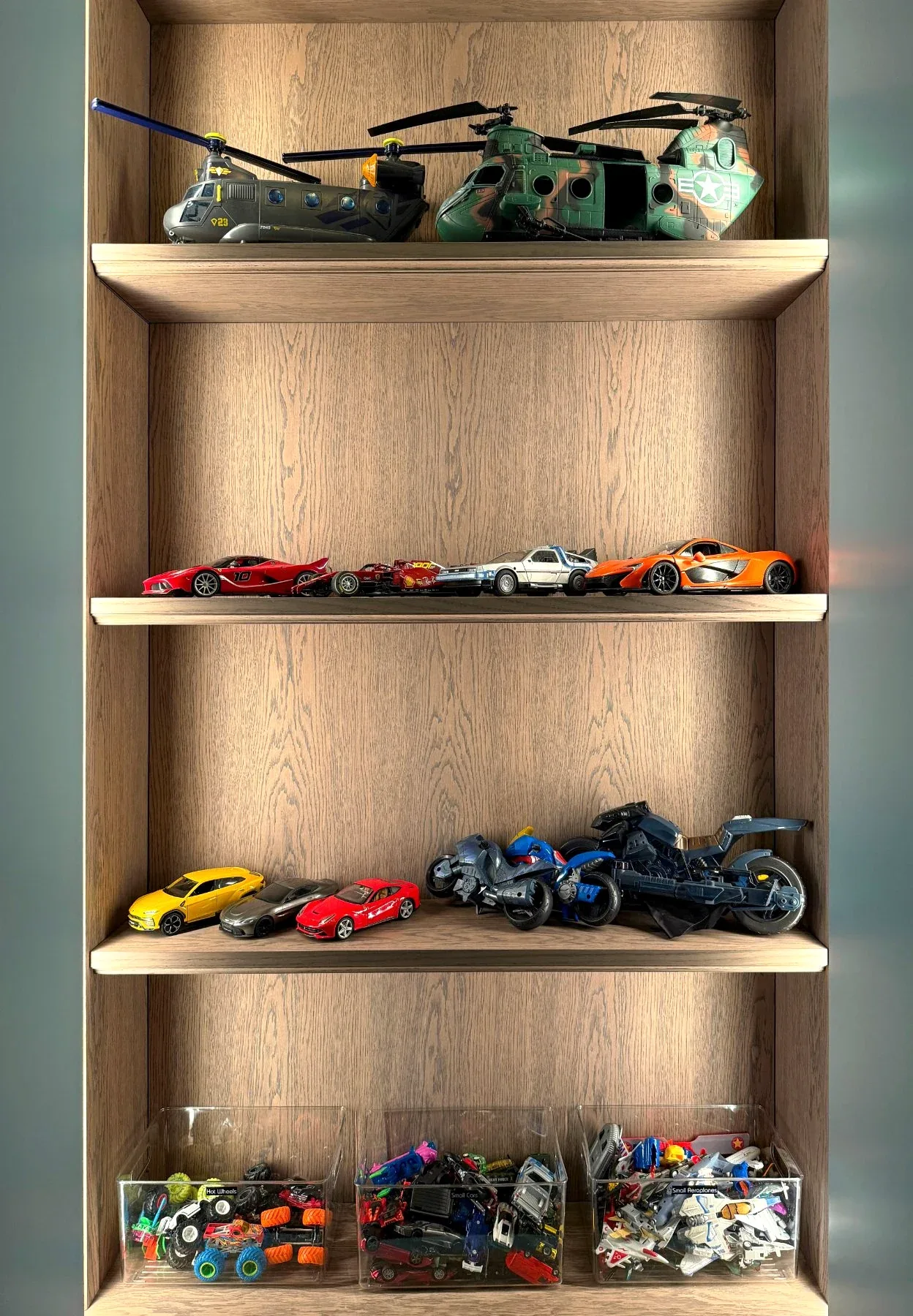 Model aircraft and toy cars ranged along the shelves of a timber niche.