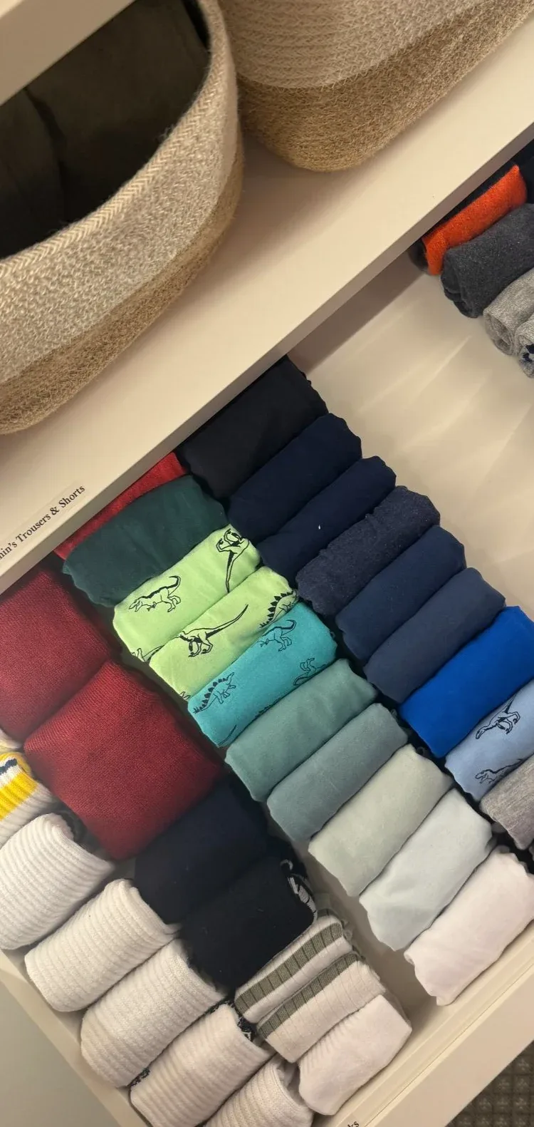 A drawer of socks and underwear folded into compartments.