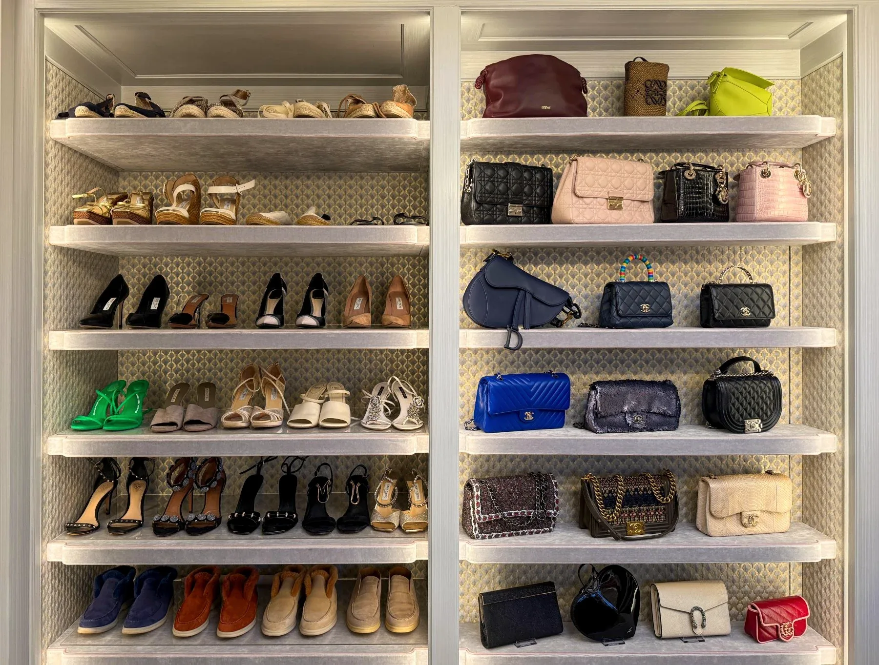 Shoes and handbags arranged across open white shelving.