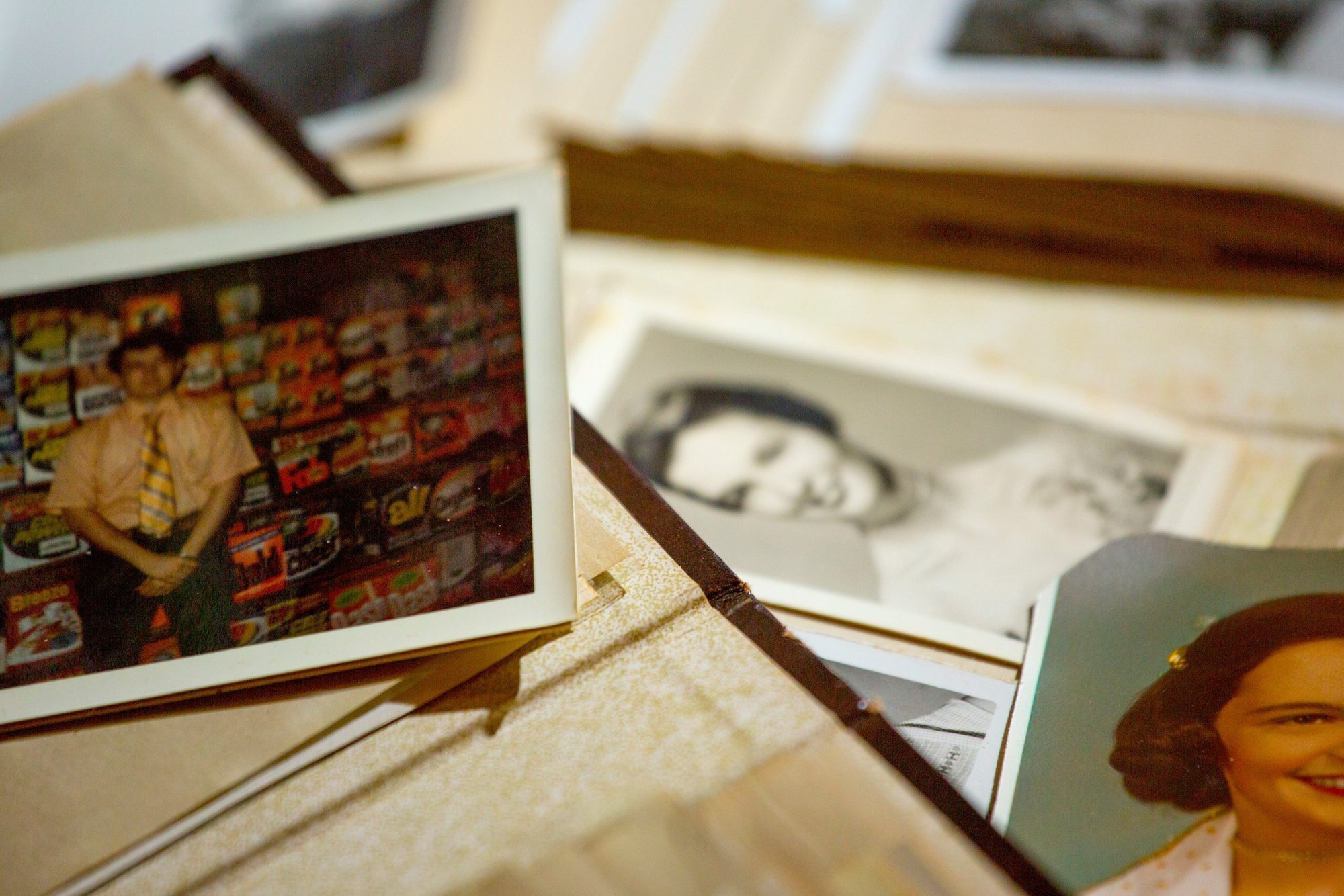 Printed photographs and a framed picture laid out together.