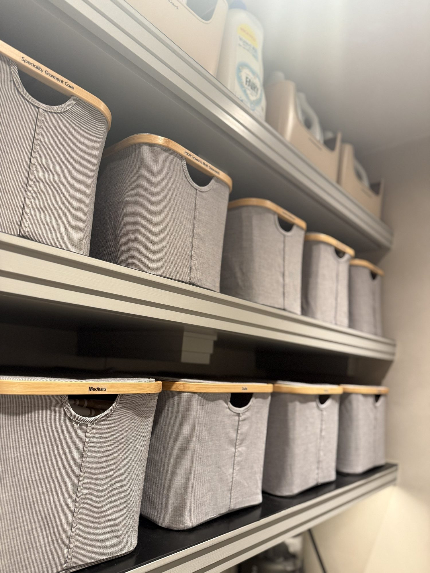 Fabric storage boxes lined up on shelves.